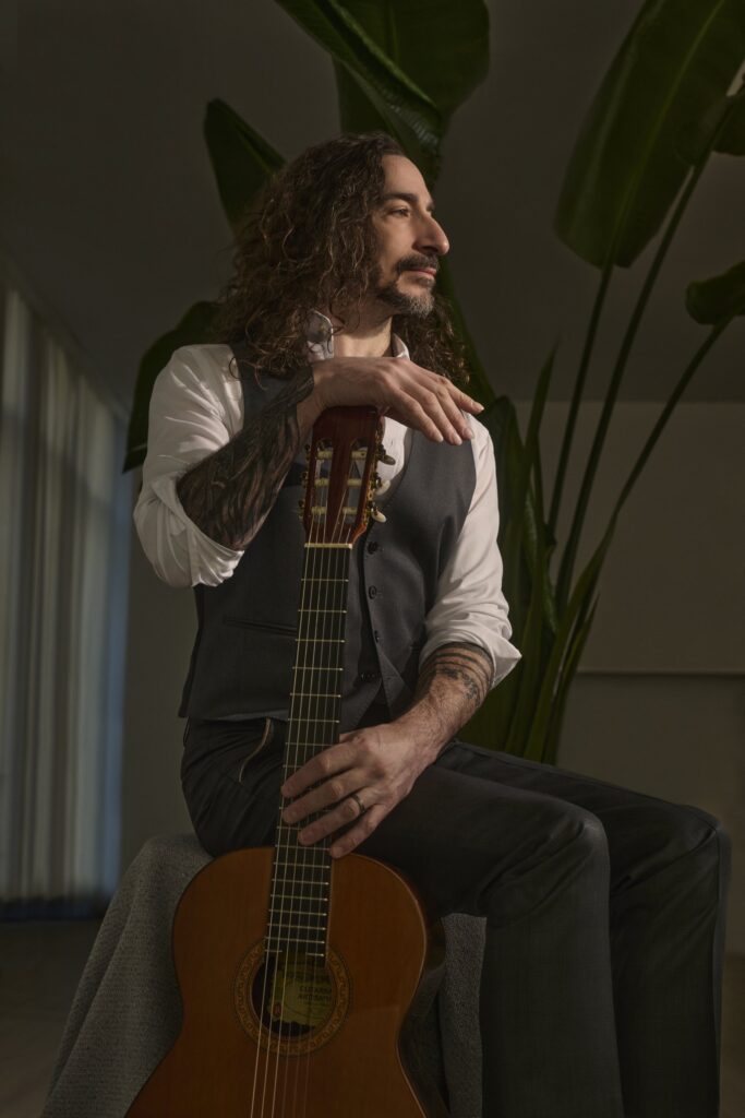 Michael Hewett with guitar. Image Credit - Michael Hewett