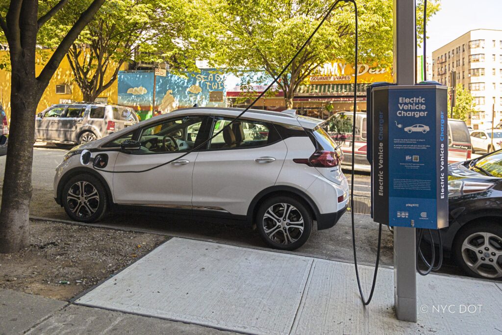 A car plugged into a curbside electric vehicle charger in the Bronx. A car plugged into a curbside electric vehicle charger in the Bronx. Credit: NYC DOT